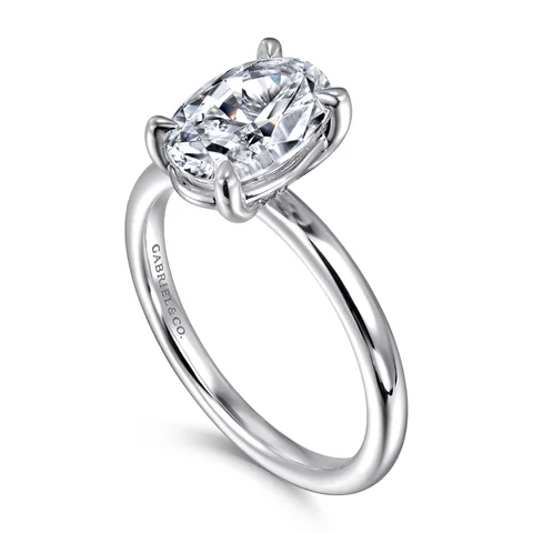 An oval solitaire engagement ring by Gabriel & Co. in white gold