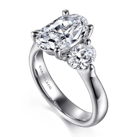 An oval three-stone engagement ring by Gabriel & Co. in white gold