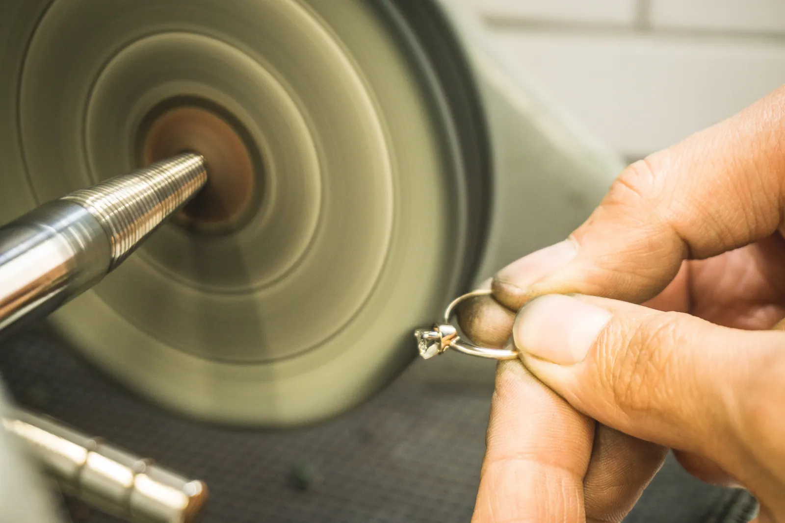 A ring held to the polishing wheel at the bench